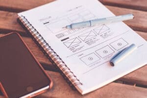 Website wireframe sketches illustrating how to split service pages into focused pages for different services.