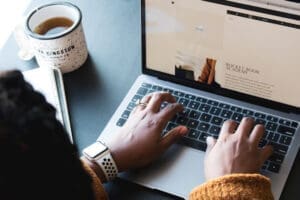 Case studies vs testimonials represented by a business website being viewed on a laptop to help customers assess a company’s credibility.